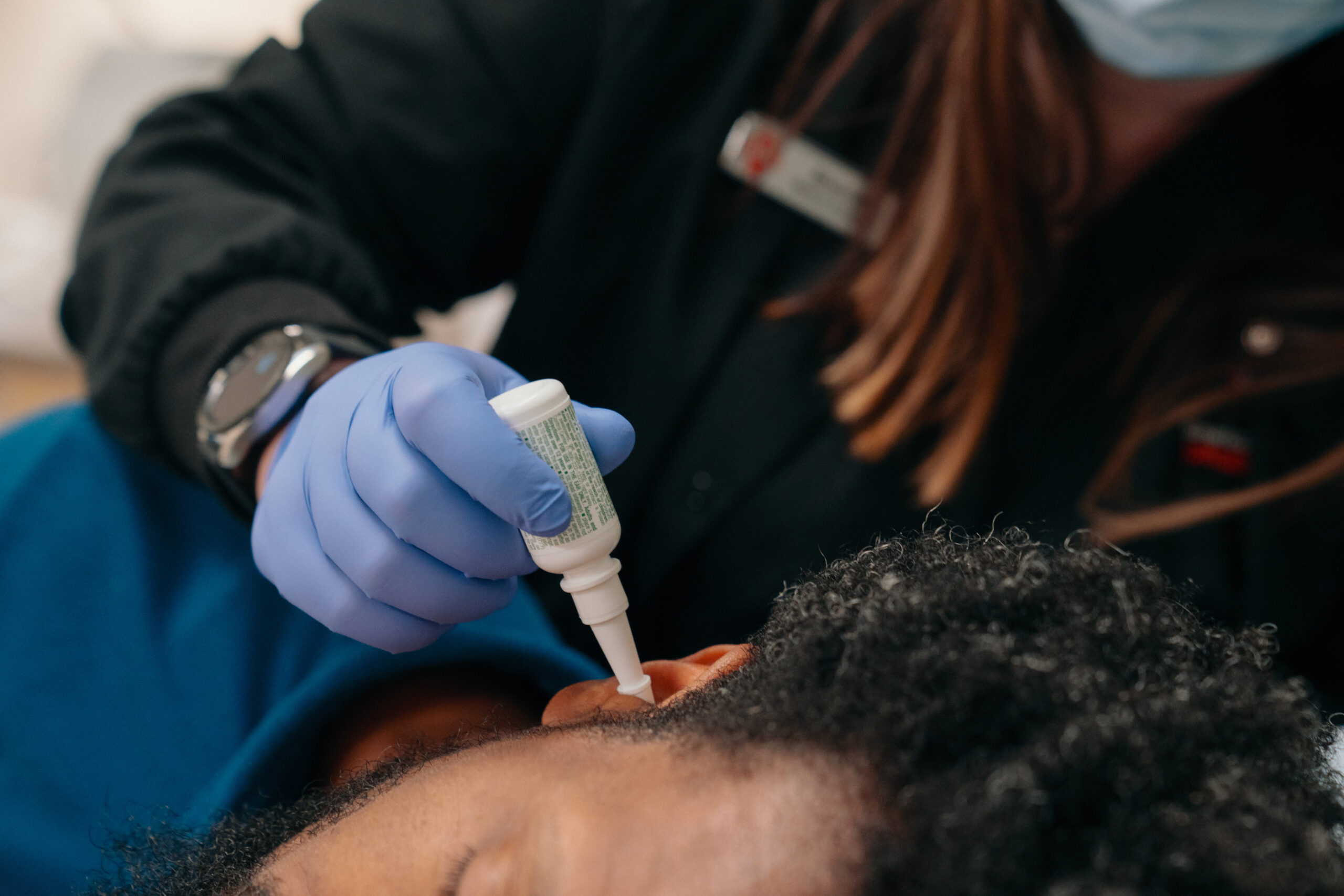 Man receiving ear treatment at an AFC Urgent Care clinic.
