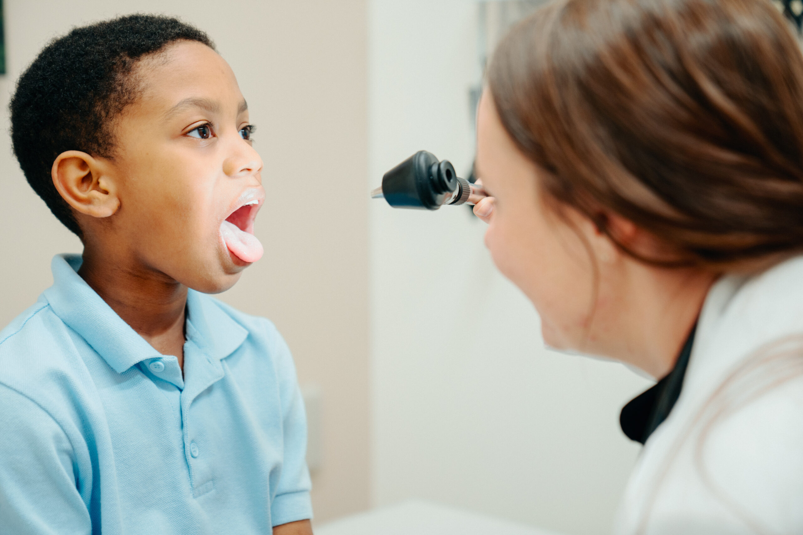 AFC provider checks young patient's throat